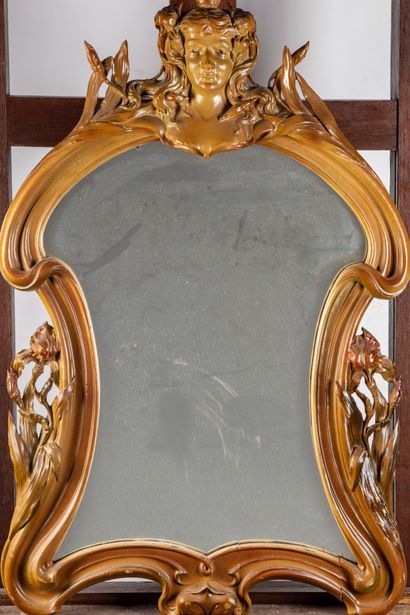 null Carved wood mirror with woman and iris decoration in the Art Nouveau style

Around...