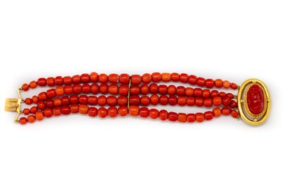 Coral beads bracelet on four rows adorned...