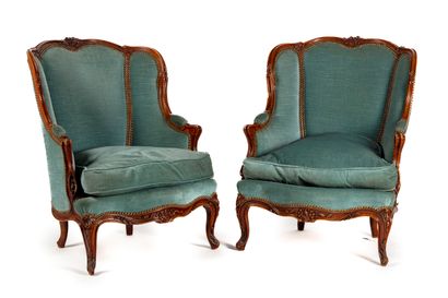 null Pair of bergères in natural wood decorated with moldings and carved with foliage...