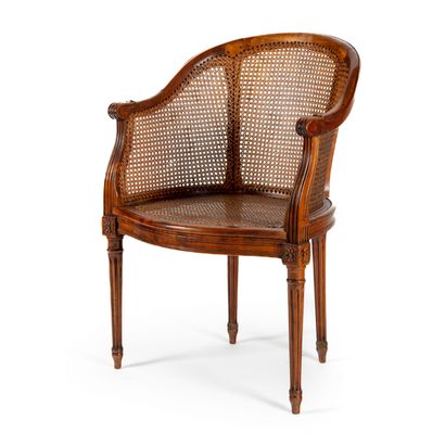  Office armchair in natural wood. Gondola back and seat upholstered with cane. Fluted...