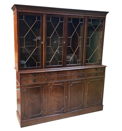  Mahogany and mahogany veneer bookcase. The upper part opens with four glazed doors...