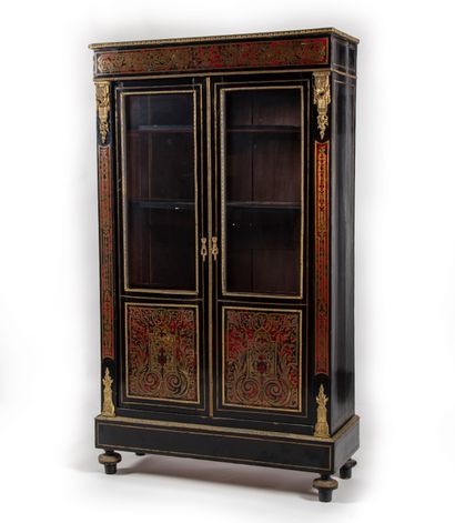  Bookcase in Boulle marquetry in brass on a red tortoiseshell background, opening...
