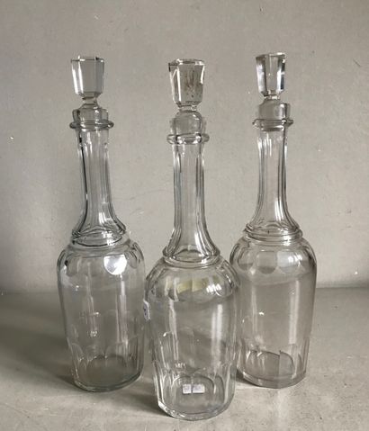 Suite of three large covered glass decanters...