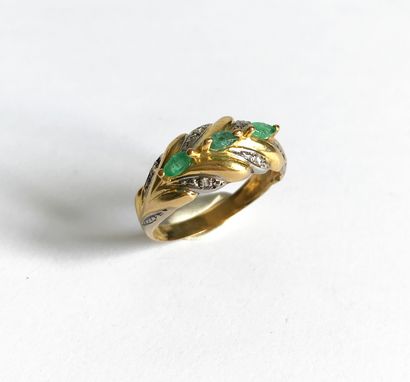 null Yellow gold ring set with a foliage pattern set with three small navette emeralds...