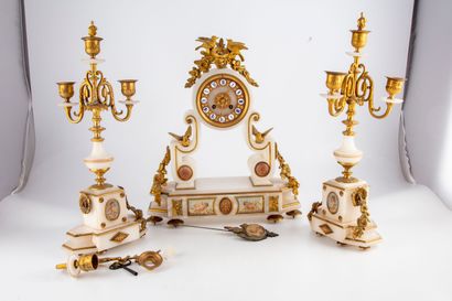null White marble mantel set with gilded ornaments composed of a portico clock crowned...