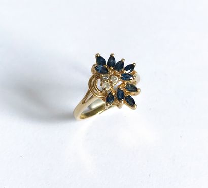 null Yellow gold ring set with a floral design of small navette sapphires and small...
