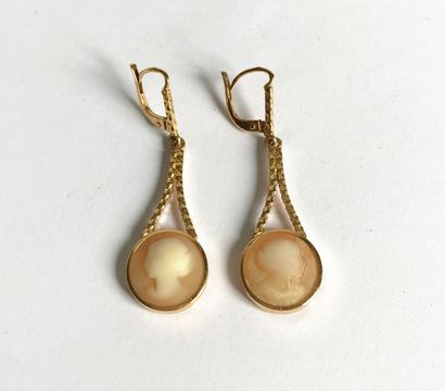 Pair of yellow gold earrings holding round...