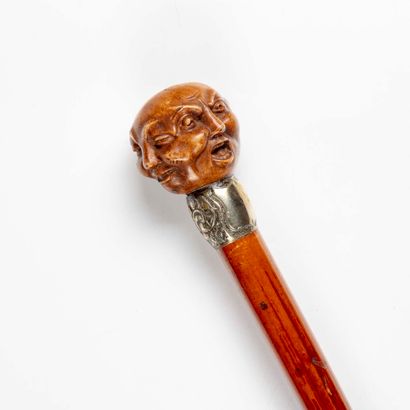 null Cane, the pommel probably in boxwood carved forming a head with four grimacing...