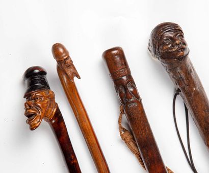 null Set of four grotesque canes:

-Gnarled wood cane with handle carved with a bearded...