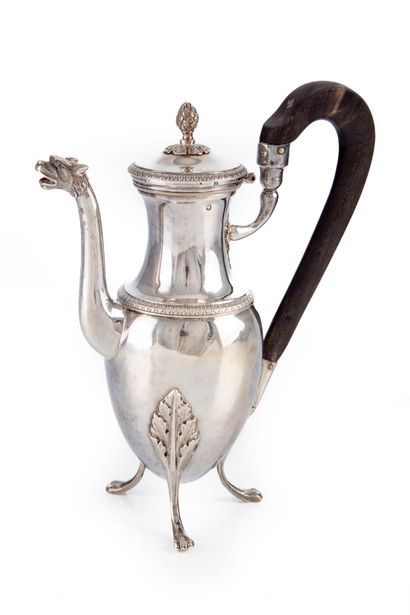 null Small silver coffee pot resting on three feet ended by claws, the body decorated...