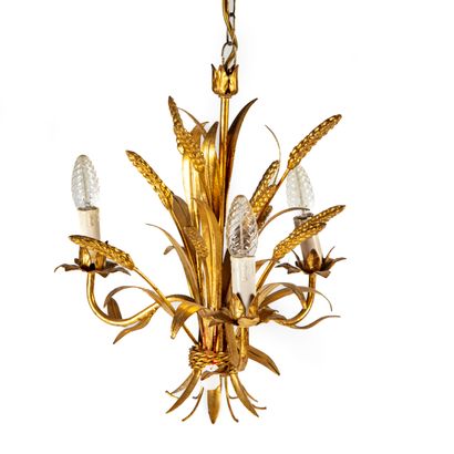 null Pair of gilded metal chandeliers with four arms of light with a central motif...