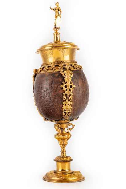 null Coconut with gilded copper frame richly chiseled with foliage and characters...