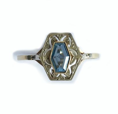 null Gold ring set with a polygonal colored stone in an openwork frame stylizing...