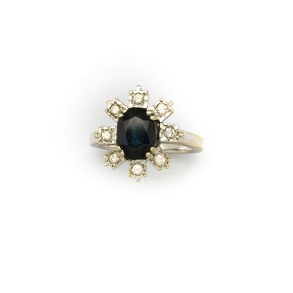 Daisy ring set with a sapphire surrounded...