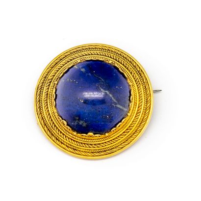  Broche en or jaune ornée d'une pierre bleue en cabochon 
Poids brut : 13,9 g.