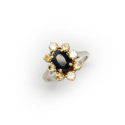 Ring with surround, in the center a sapphire...