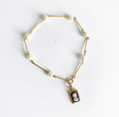 Yellow gold and pearl bracelet with a charm...