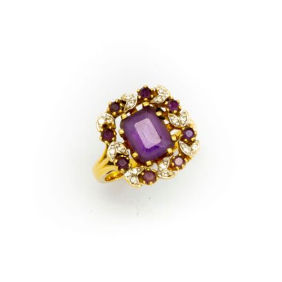 null Yellow gold ring set with an amethyst surrounded by small diamonds and small...