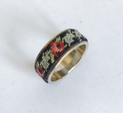 Metal ring sheathed with a fabric band embroidered...