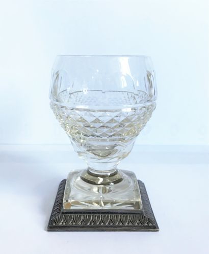 null Glass with foot out of cut crystal. The base circled with chased metal.

H....