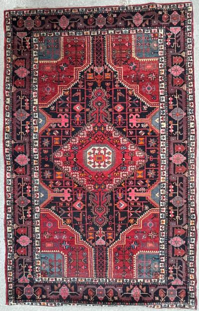 null Persian carpet with geometric decoration on a red and blue background, triple...