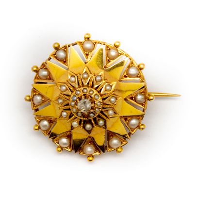 null Broche en or jaune formant un soleil ornée de perles, en son centre un petit...