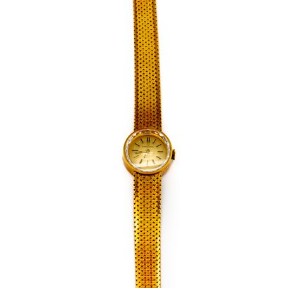 ETERNA ETERNA 
Watch in yellow gold, the dial surrounded by small scalloped mirrors
Gross...