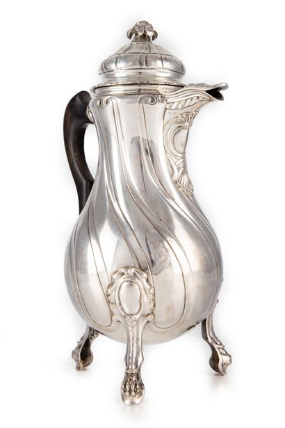 null Silver coffee pot with torso rib tripod base ending in claw feet, flower-shaped...
