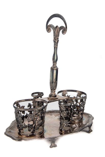 null A silver oil cruet with a contoured rim, standing on four feet, the frames with...