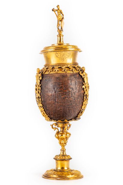 null Coconut with gilded copper frame richly chiseled with foliage and characters...