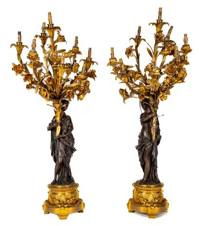 null Pair of candelabras in bronze with two patinas. The shaft in the shape of a...