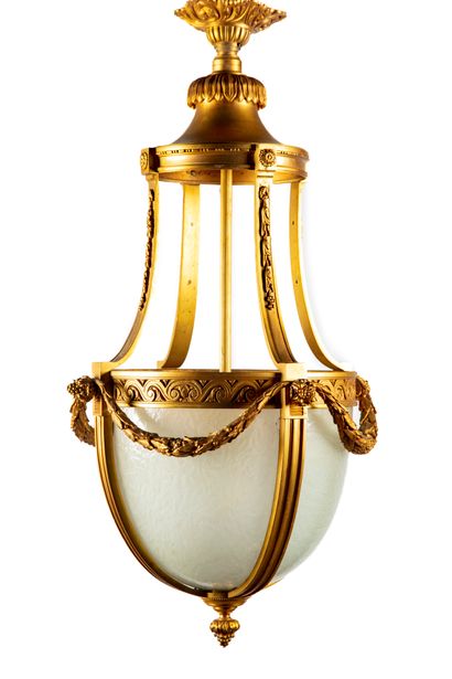 null A gilt bronze chandelier decorated with a geometric frieze and laurel garland,...