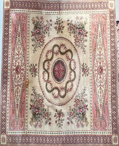 null Rectangular wool carpet decorated on beige field of a central medallion framed...