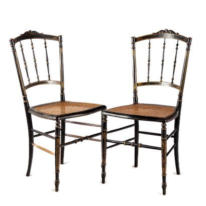 Pair of chairs in blackened wood, cane seat....