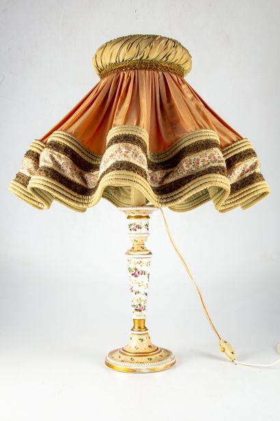 null Porcelain candlestick with polychrome decoration of flowers, and gilded nets....