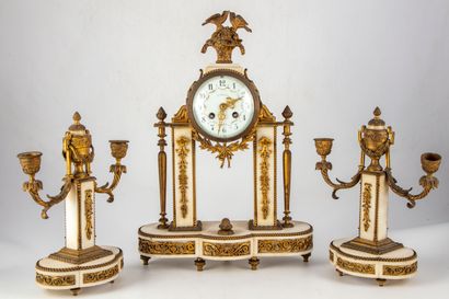 null White marble mantel set with gilded brass ornaments composed of a portico clock...