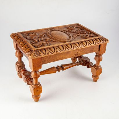 null Small footrest in natural wood decorated with a medallion surrounded by foliage...