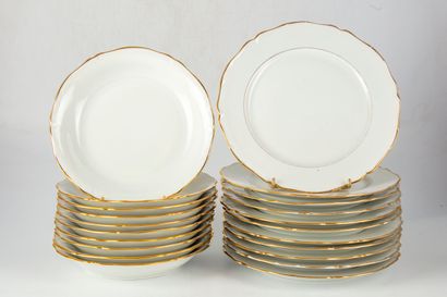null Part of a porcelain dinner service with scalloped edge and gilded net, including...