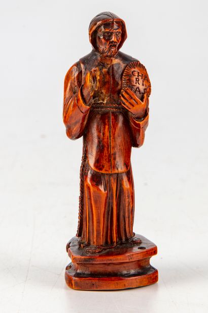 null Small stauette representing Saint Francis of Paul holding a medallion with the...