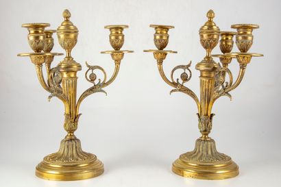 null Pair of ormolu candlesticks with three arms of light decorated with a frieze...