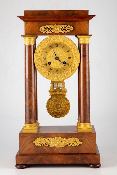 null Mahogany and mahogany veneer portico clock with four columns framing the dial...