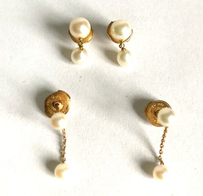 null Two pairs of gold and cultured pearl earrings each consisting of a pearl mounted...