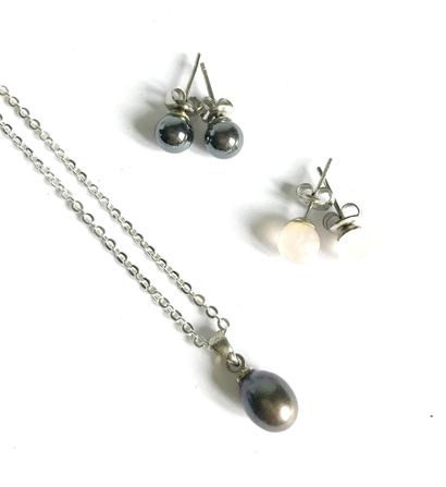 White gold pendant and gray pearl drop suspended...