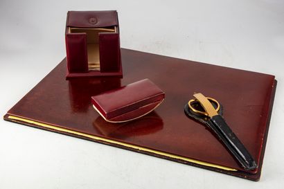 null Red leather desk set including a paper dispenser, a drinking cup and a coaster....