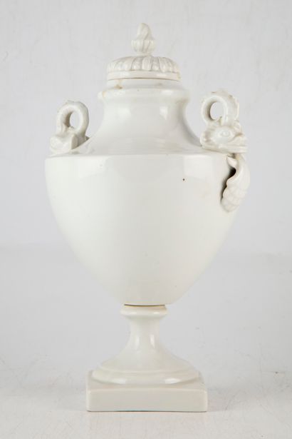 null Covered vase of baluster form, the handles in the shape of dolphins and shells....