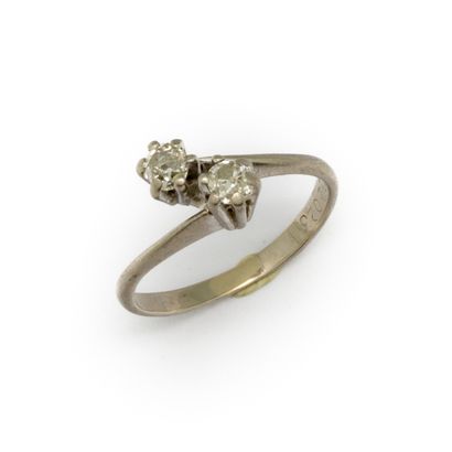 null Ring in white gold paved with two small diamonds in you and me weighing approximately...