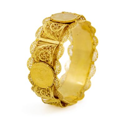 null Bracelet rigide en or jaune (750 millièmes) orné de 4 pièces de 20 francs or...