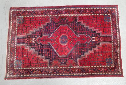 null Small Turkish wool carpet with geometric and crenelated motifs on a red background....