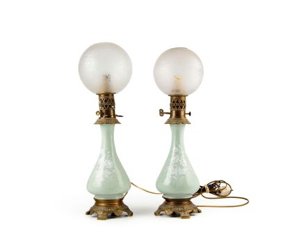 null Pair of oil lamps 
The celadon-green porcelain body in the shape of a Chinese...