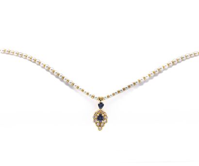 null Pearl necklace punctuated with small gold beads, finished with a pendant adorned...